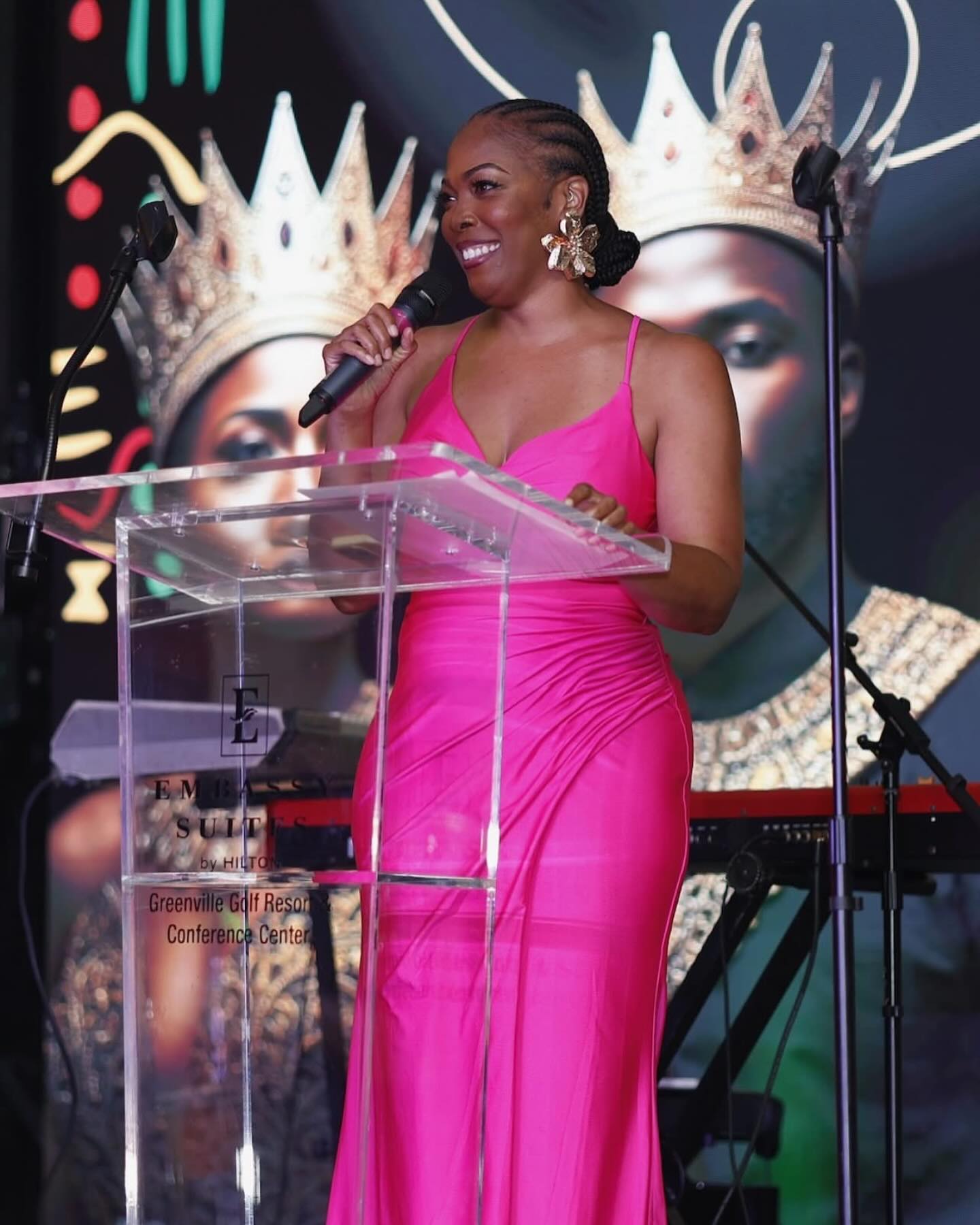 April smiling while speaking into a microphone at an event